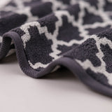 Close-up of a textured gray and white patterned fabric on a light background