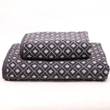 Two patterned towels stacked on a white background