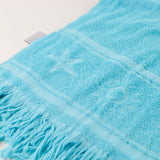 Close-up of a Aqua towel with fringes on a white background