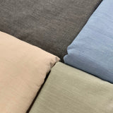Close-up of fabric swatches in gray, beige, and blue.