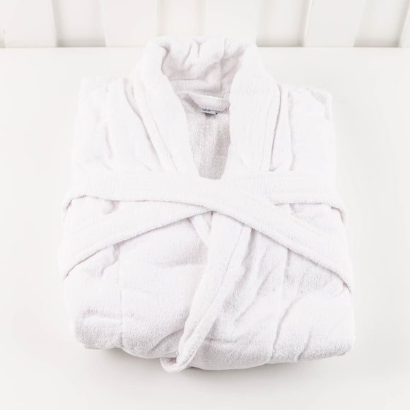Folded white towel on a white surface