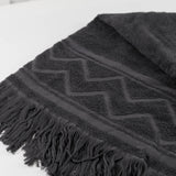 Dark Gray towel with zigzag pattern and fringes on a white background